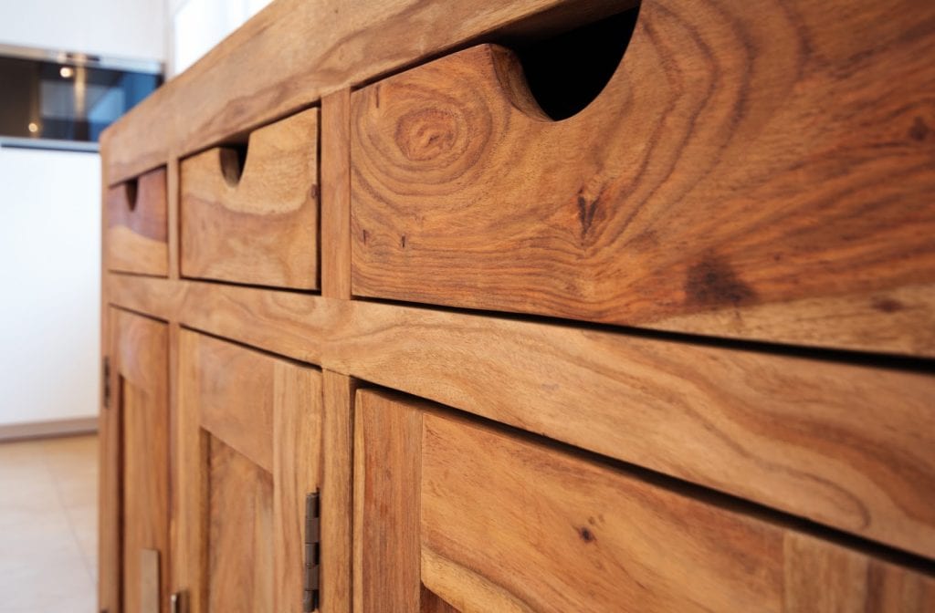 close up of a wooden cabinet with 3 drawers and 3 cupboards