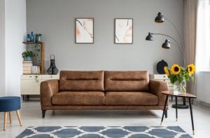 A high-quality leather couch sitting in a decorative living room