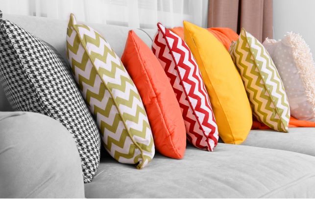 Colorful pillows placed on top of sofa