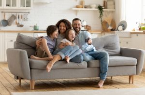 Family sitting with one another in family room after tips from Birchwood Furniture