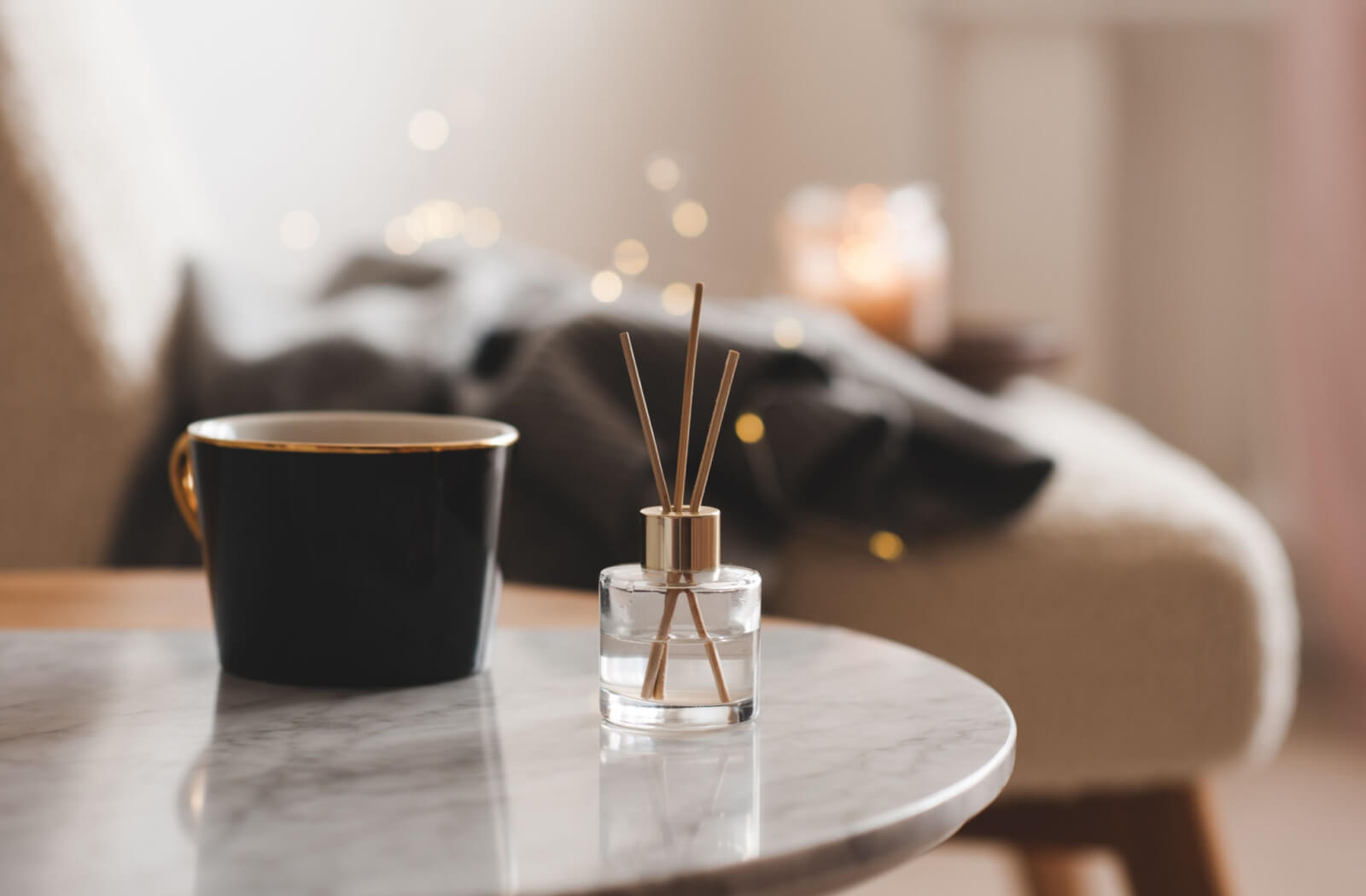 A close-up of a marble coffee table with a cup of coffee on it.