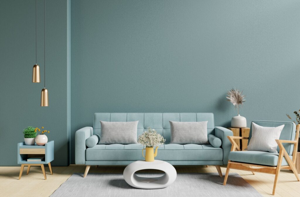 A modern living room with a light blue design theme and several accent pieces, including a small side table and an accent chair.